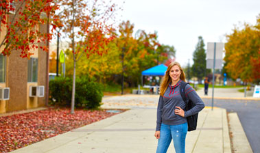 Student at bus stop on Yuba College campus